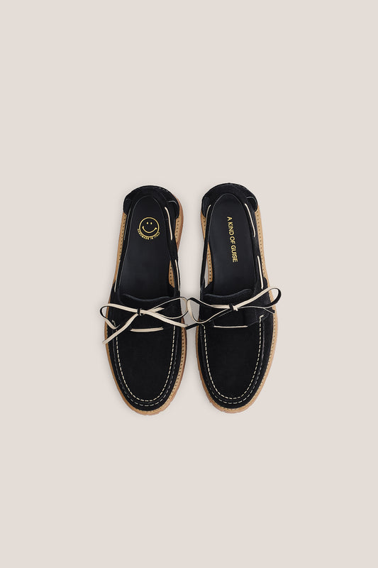 Women's accessories boat sandal, black Italian vegetal cowhide, white lacing, and natural sole.