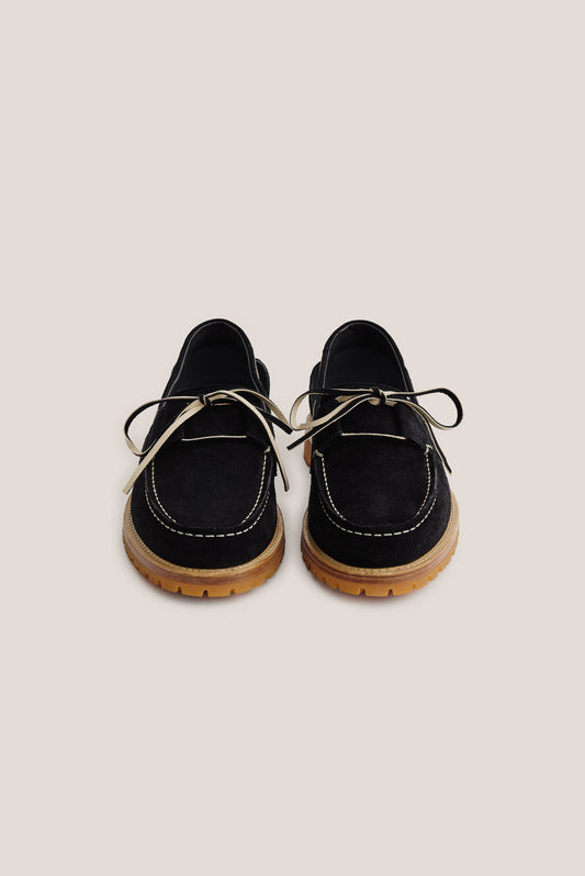 Women's accessories boat sandal, black Italian vegetal cowhide, with white stitching and tan lug sole.