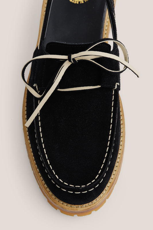Men's accessories sandal, black Italian vegetal cowhide, boat-style with white lacing and stitching.