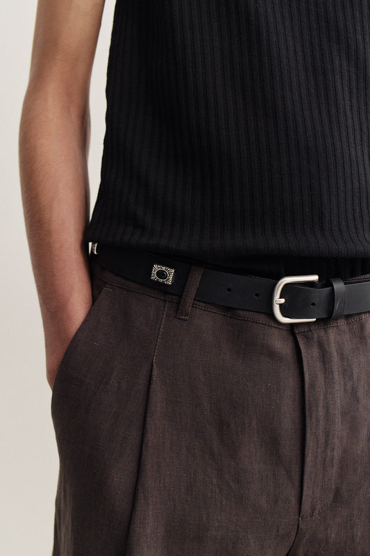 Men's accessories, Duniro Belt, black calf leather with vintage finish, silver buckle, worn with brown trousers.