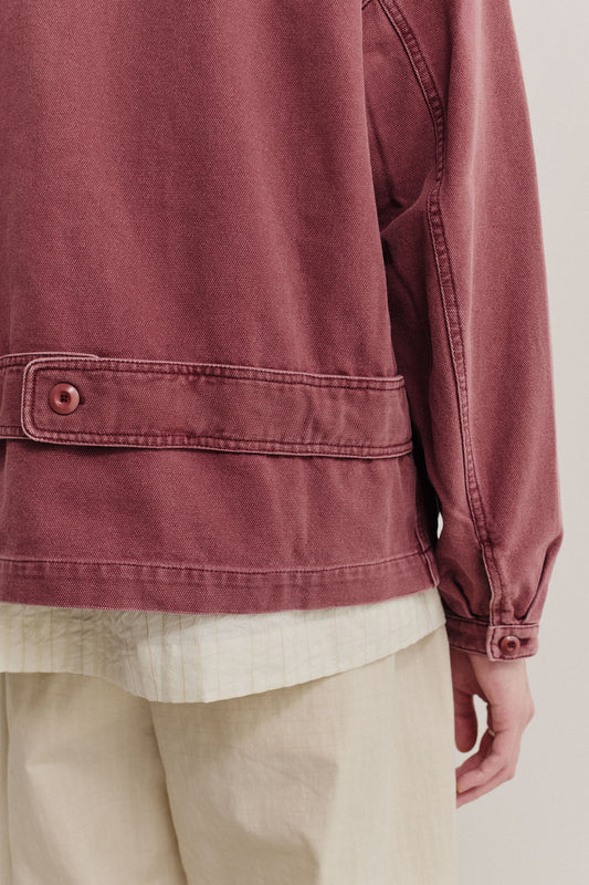 Men's outerwear jacket, organic cotton, stone washed, maroon, with back strap detail and buttoned cuffs.