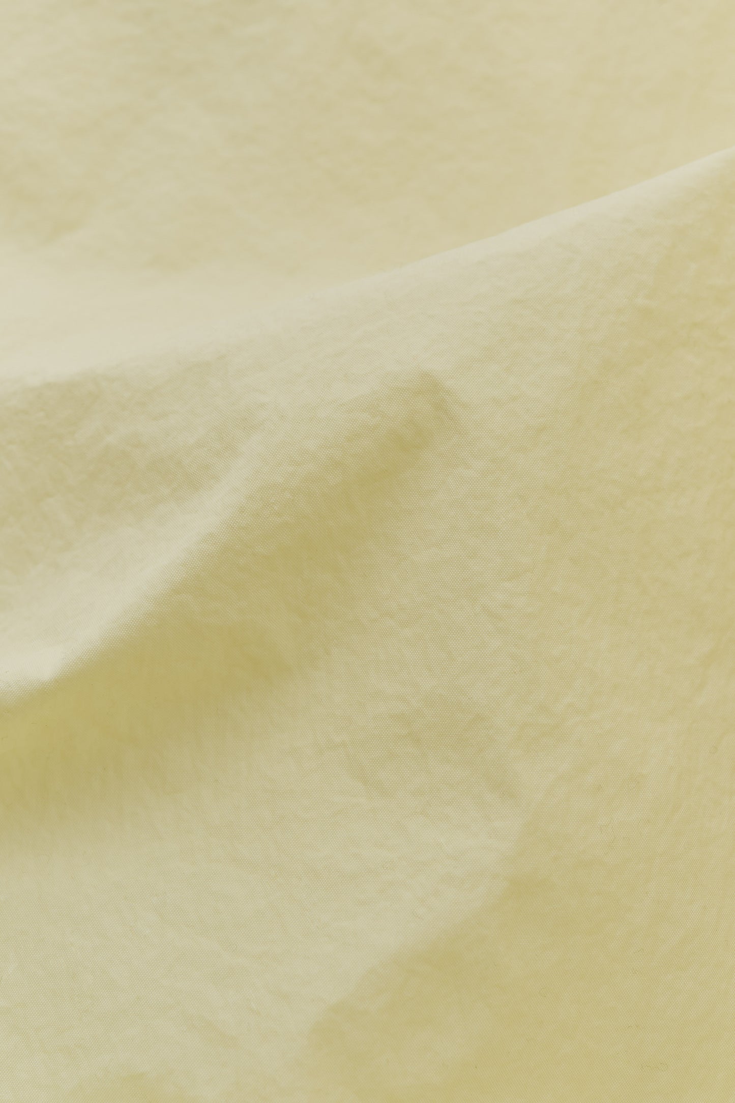 Men's shorts, recycled polyamide, garment-dyed, washed light yellow.