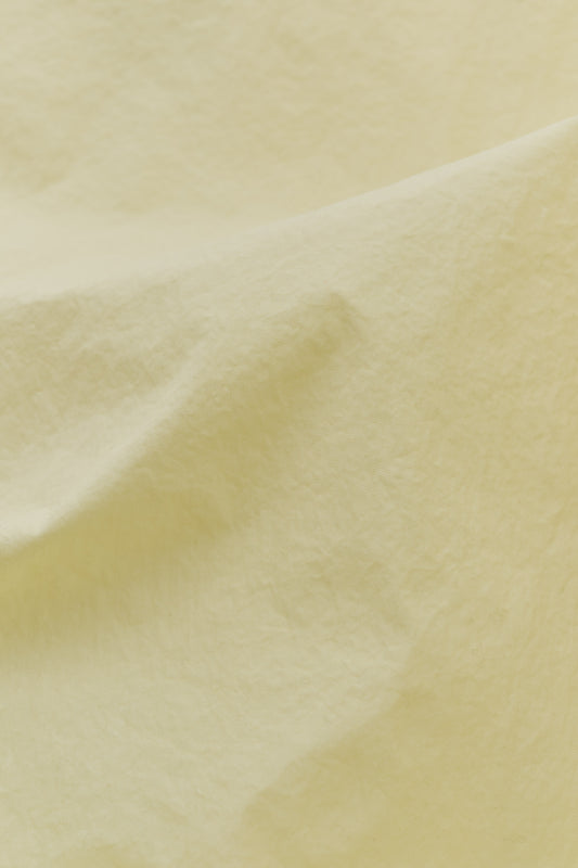 Men's shorts, recycled polyamide, garment-dyed, washed light yellow.