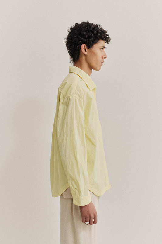 Men's long-sleeved shirt, recycled polyamide, garment-dyed light yellow, with dropped shoulder and spread collar.