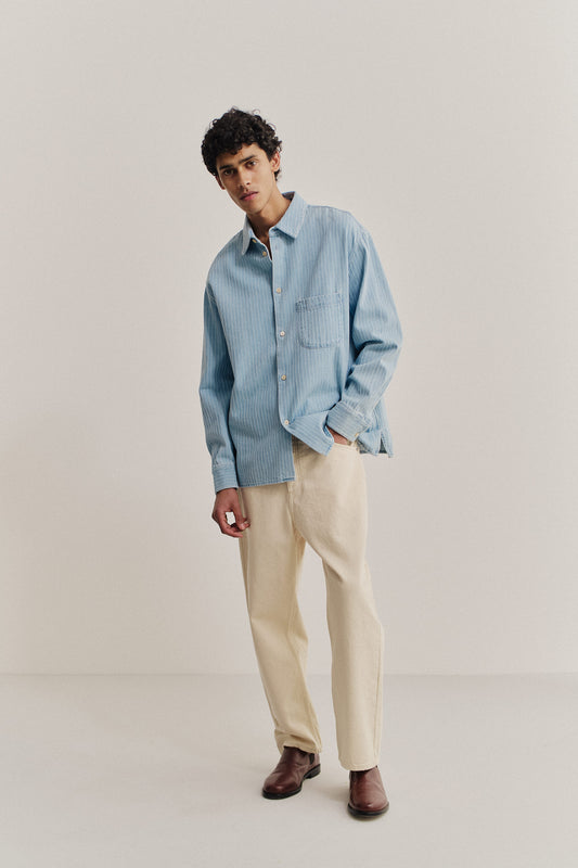 Men's long-sleeved shirt, organic cotton denim, washed light blue with pinstripes, oversized fit.