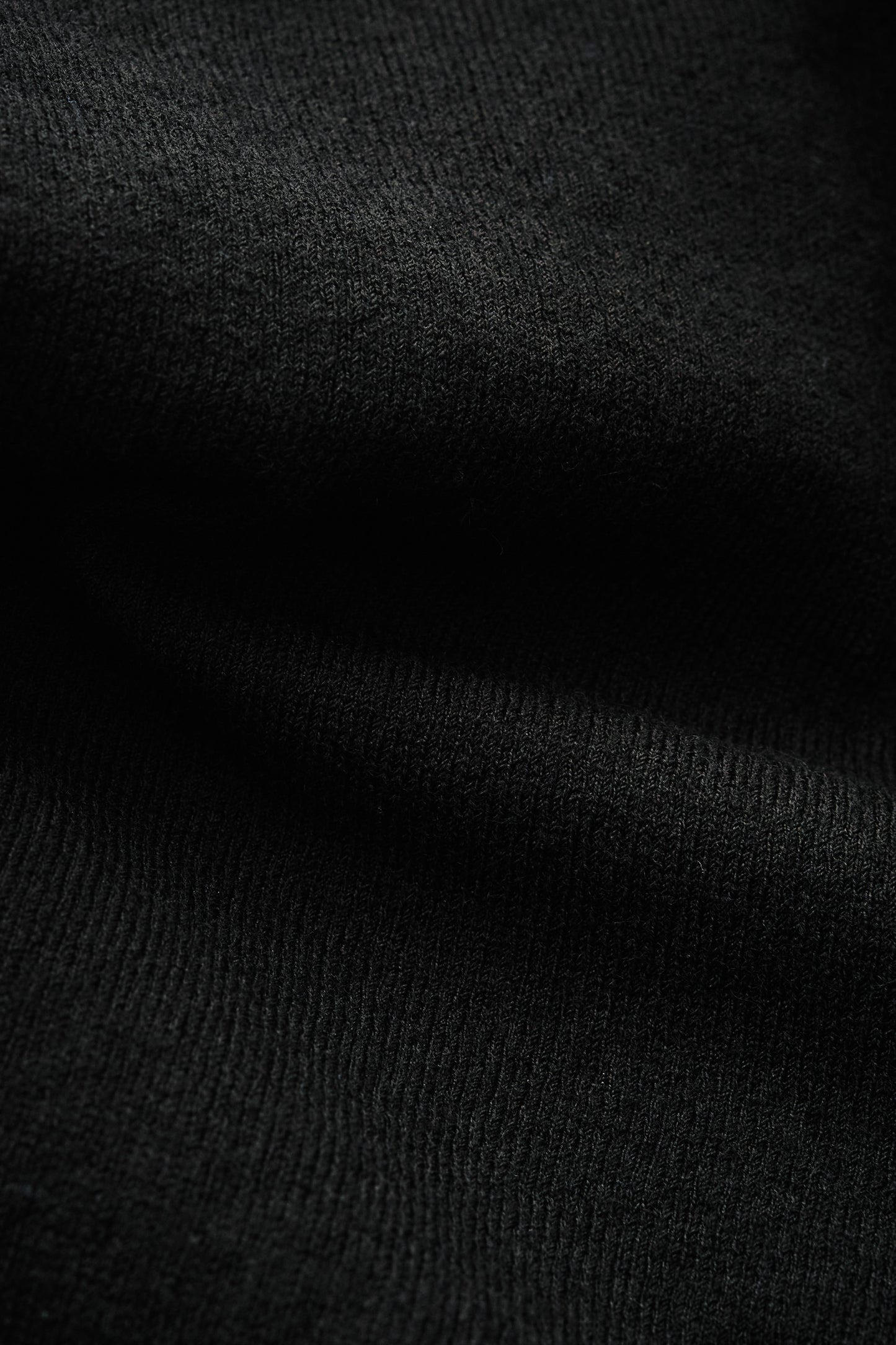 Women's knit cardigan, 100% merino wool, black, with ajour knit pattern and ribbed trim.
