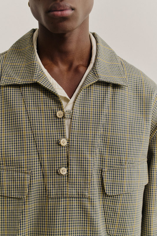 Men's long-sleeved shirt jacket, cotton houndstooth in navy, green, and yellow on beige, with patch pockets.