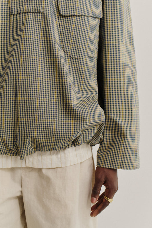 Men's outerwear shirt jacket, cotton houndstooth in navy, green, and yellow plaid, with patch pockets and adjustable hem.