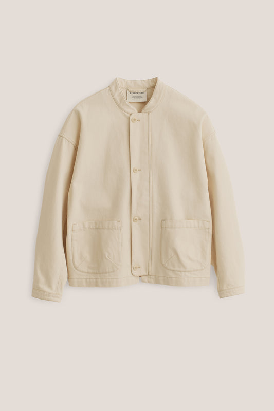Men's outerwear jacket, organic cotton raw denim, off-white, boxy fit, stand-up collar, patch pockets.