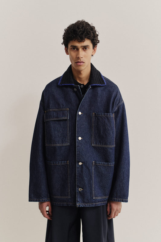 Men's outerwear denim jacket, oversized vintage blue, with knitted collar and four patched pockets.