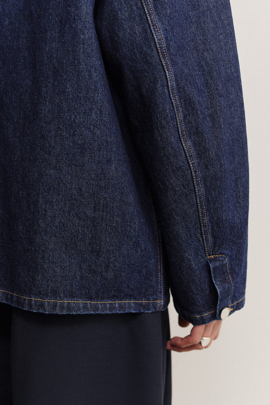 Men's outerwear denim jacket, oversized vintage blue, stone washed, with buttoned sleeve slits.