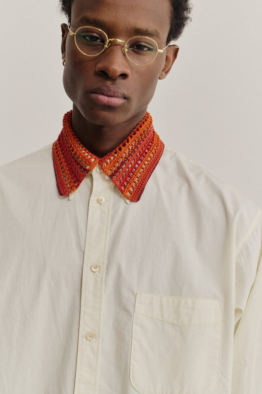 Men's accessories detachable collar, hand-crocheted merino wool in orange and red, worn over a cream cotton shirt.