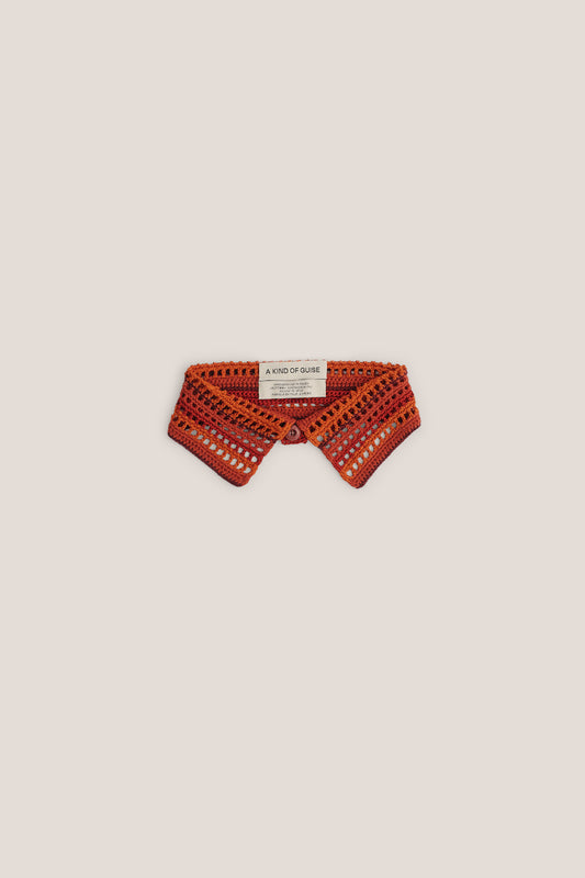 Women's accessory, hand-crocheted Kikoy Collar in orange and red merino wool, with button closure.