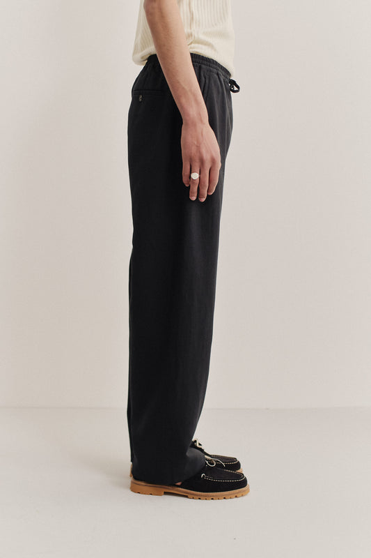 Men's long-pants, worsted wool and linen blend, black, wide straight fit with elastic waist and welt pockets.