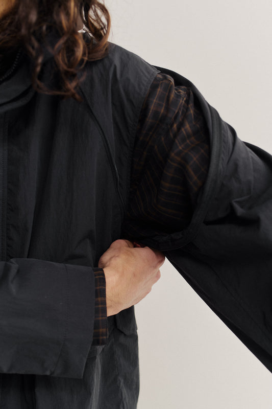 Men's outerwear, Zambezi Fisher Jacket in black recycled nylon-cotton blend, with detachable sleeves and plaid lining.