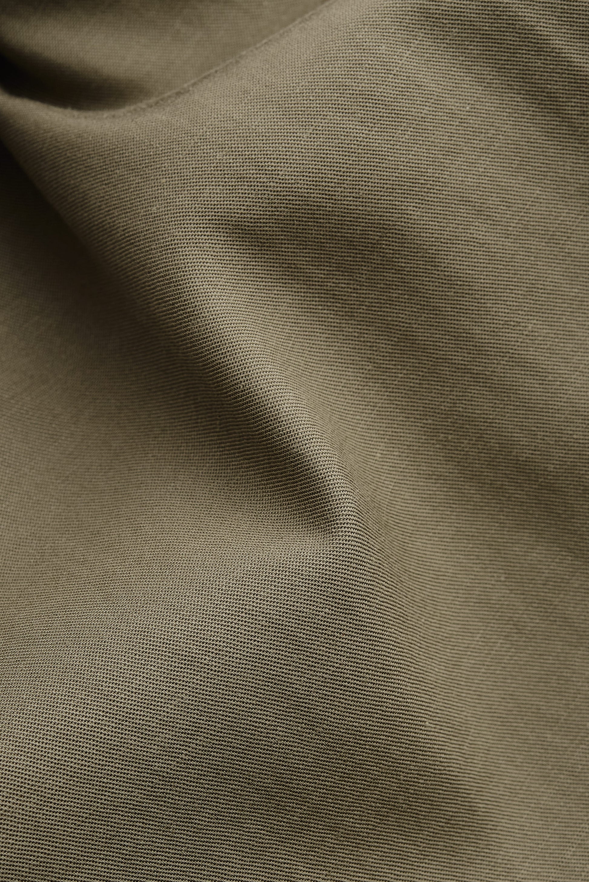 Men's shorts, lyocell-cotton-linen twill, sun-bleached sage, close-up of fabric texture.