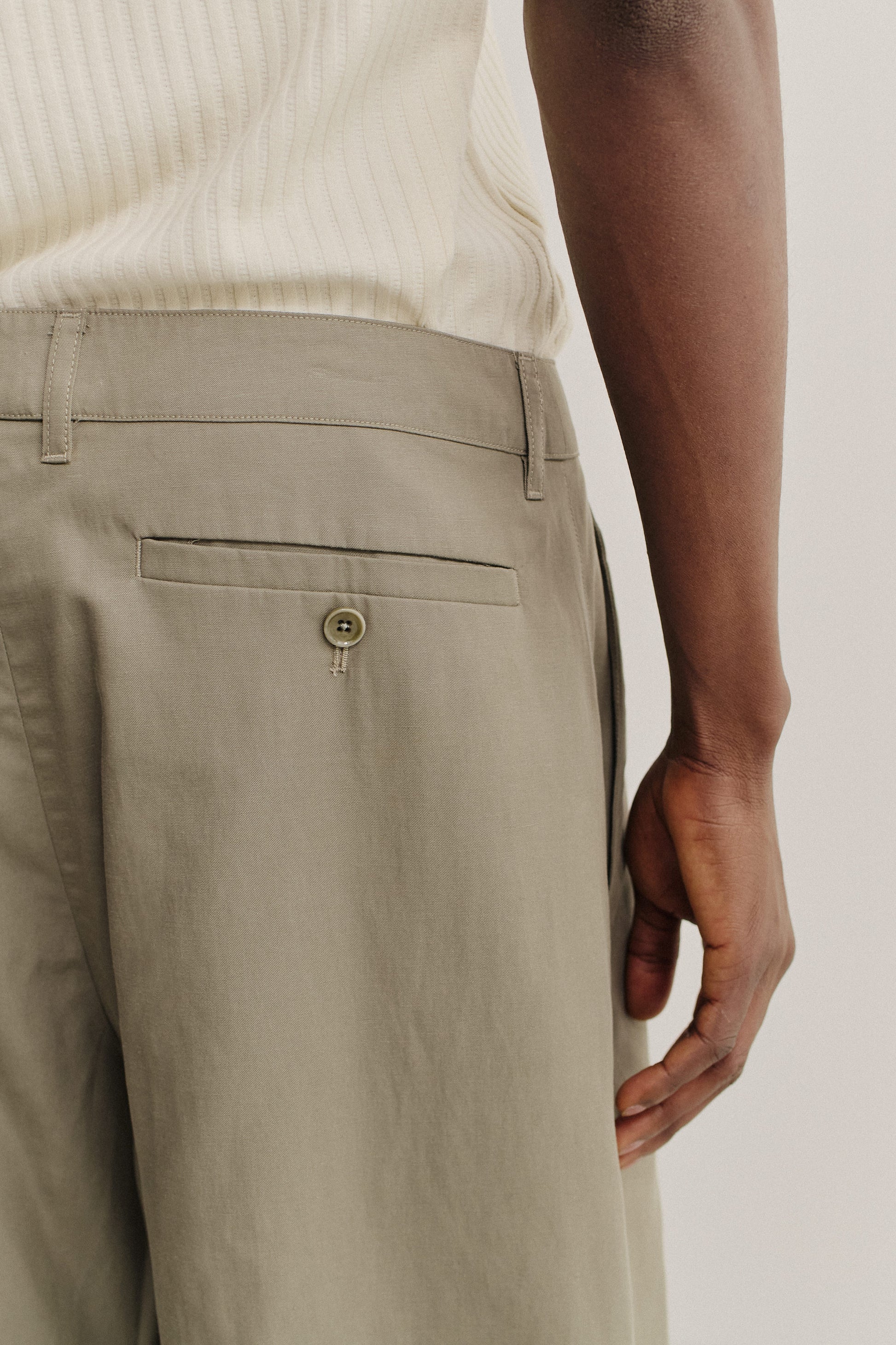 Men's shorts, lyocell-cotton-linen twill, sun-bleached sage, with back welt pocket and button closure.