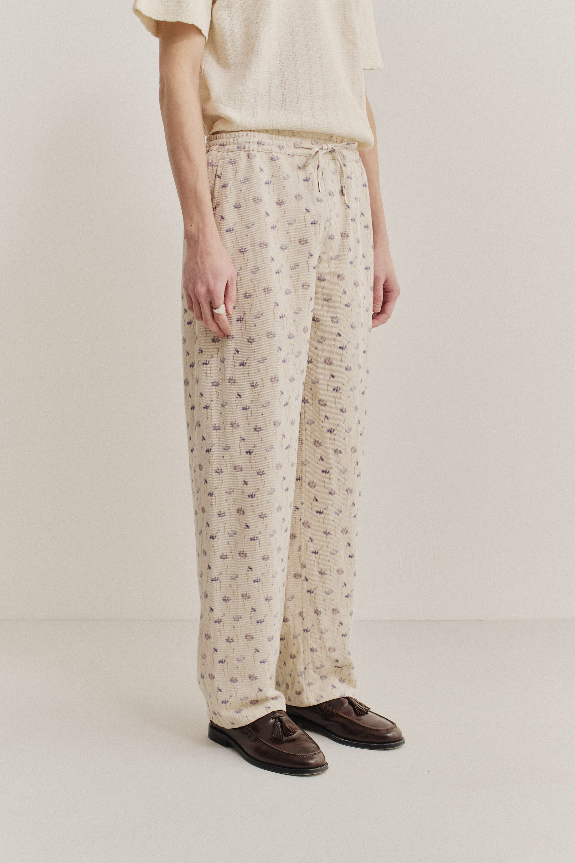 Men's long-pants, cotton-linen blend twill, ecru with subtle lilac floral print, elastic waist.