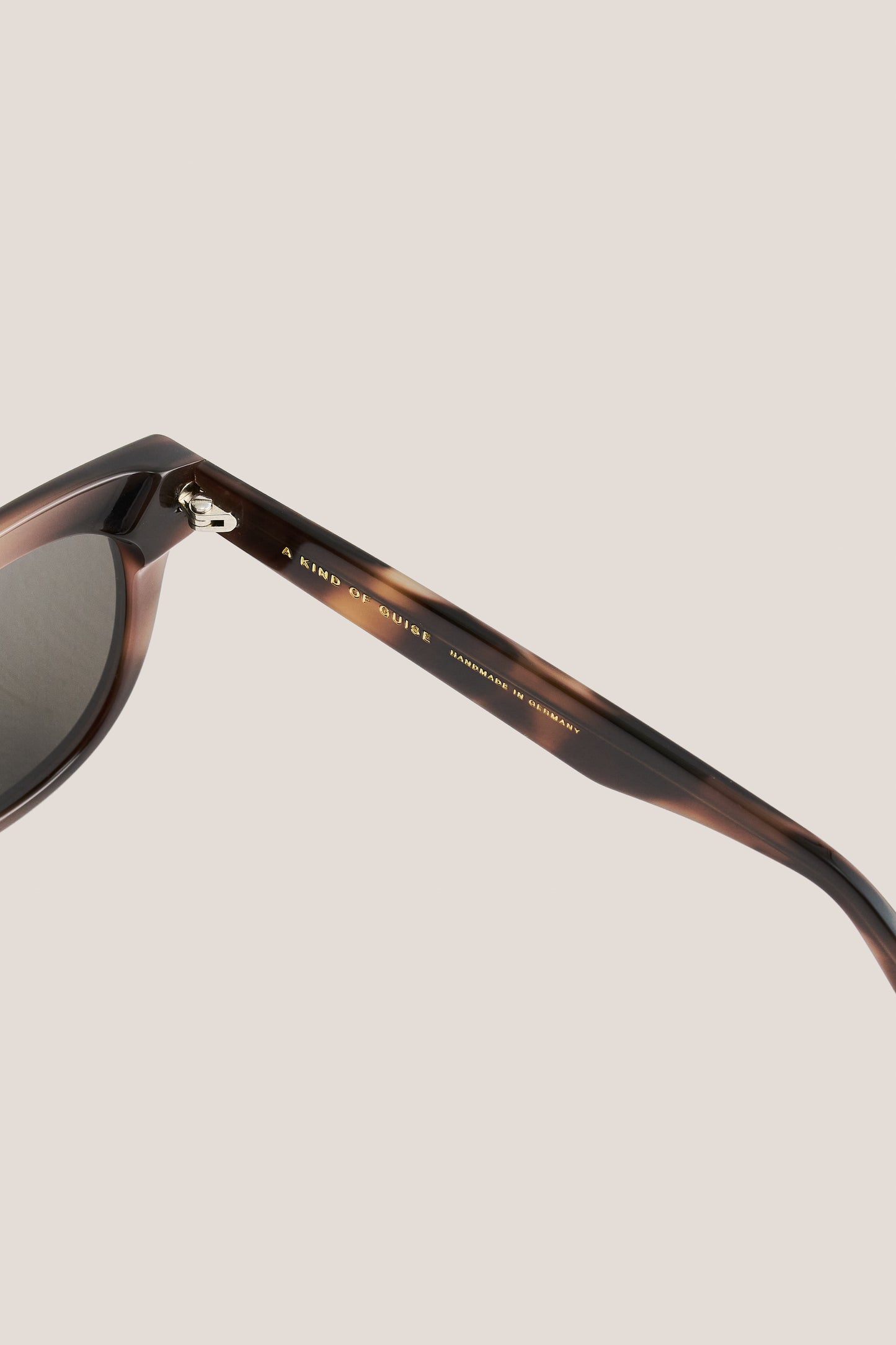 Unisex accessories sunglasses, round-shaped tortoiseshell acetate frame with dark lenses.