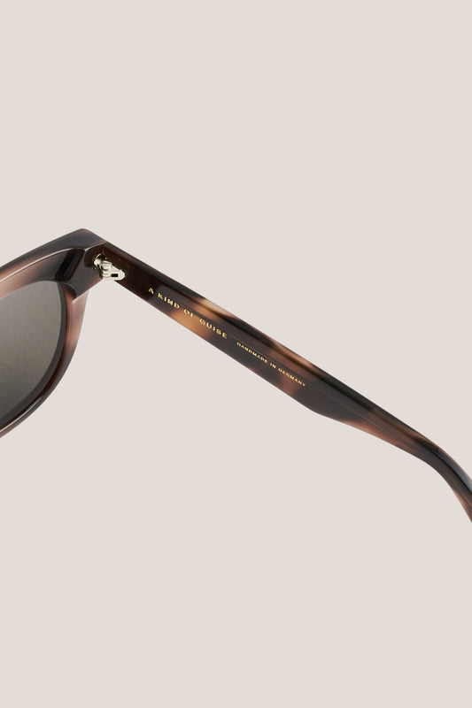 Unisex accessories sunglasses, round-shaped tortoiseshell acetate frame with dark lenses.