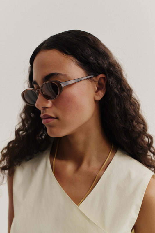 Women's accessories, oval acetate sunglasses in solid black with dark grey Carl Zeiss lenses.