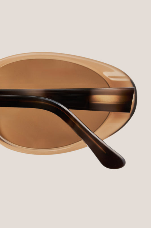 Unisex accessories sunglasses, handcrafted oval acetate frame in solid black with dark grey lenses.