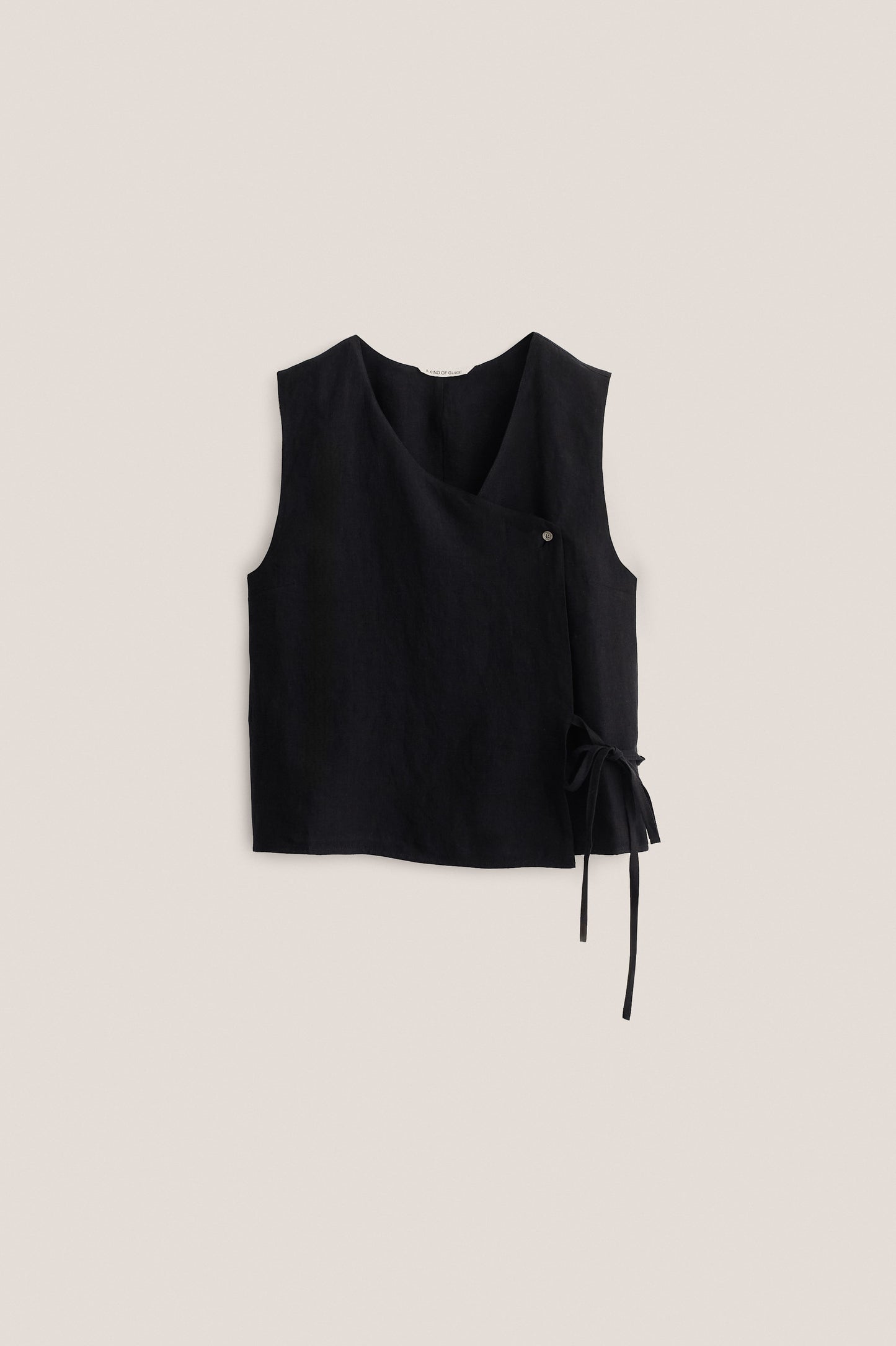 Women's sleeveless shirt, black 100% linen, asymmetric wrap front with V-neck, button, and side tie.