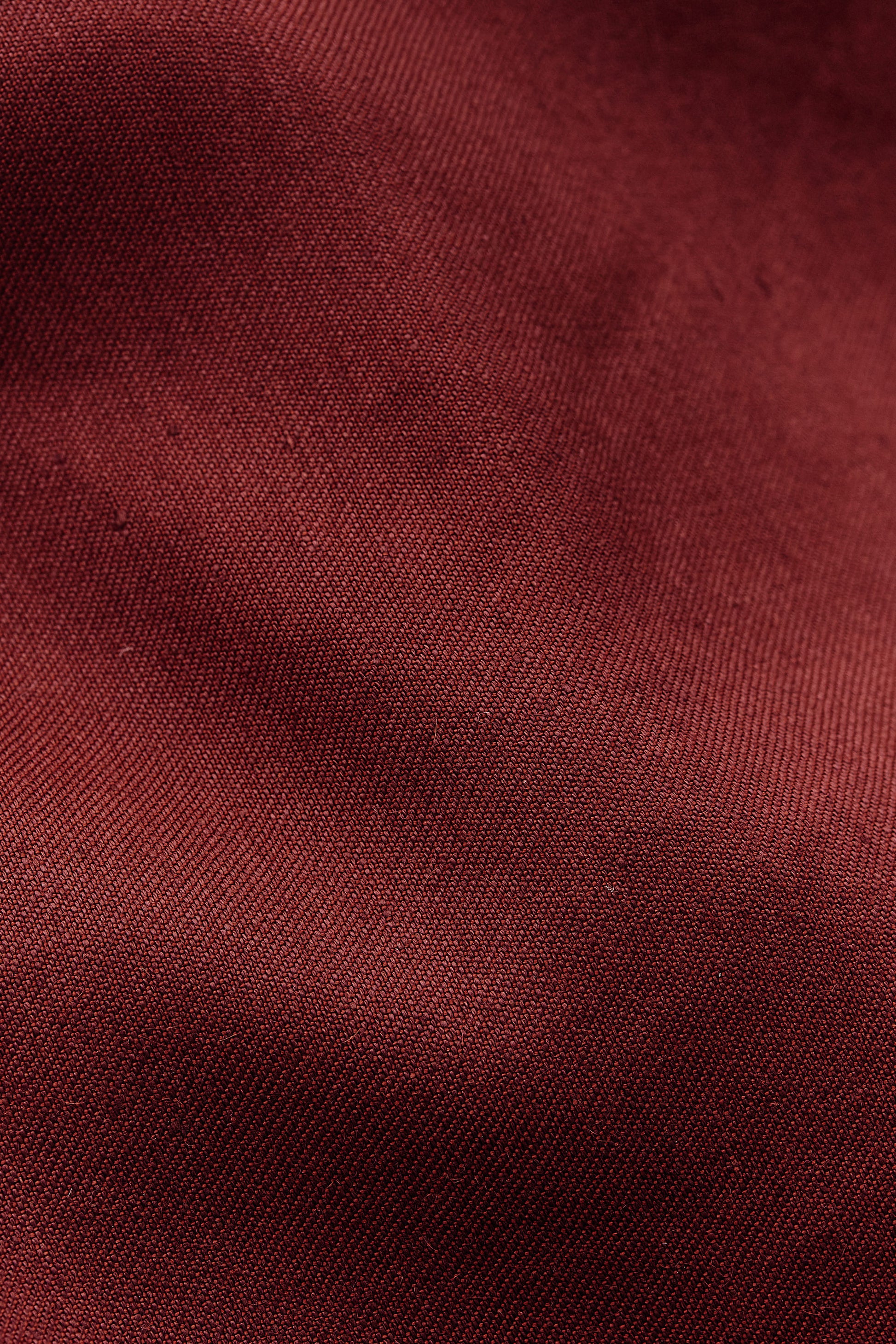 Women's sleeveless wrap shirt in a refined linen, virgin wool, and mohair blend, prunelle weave, in a rich red hue.