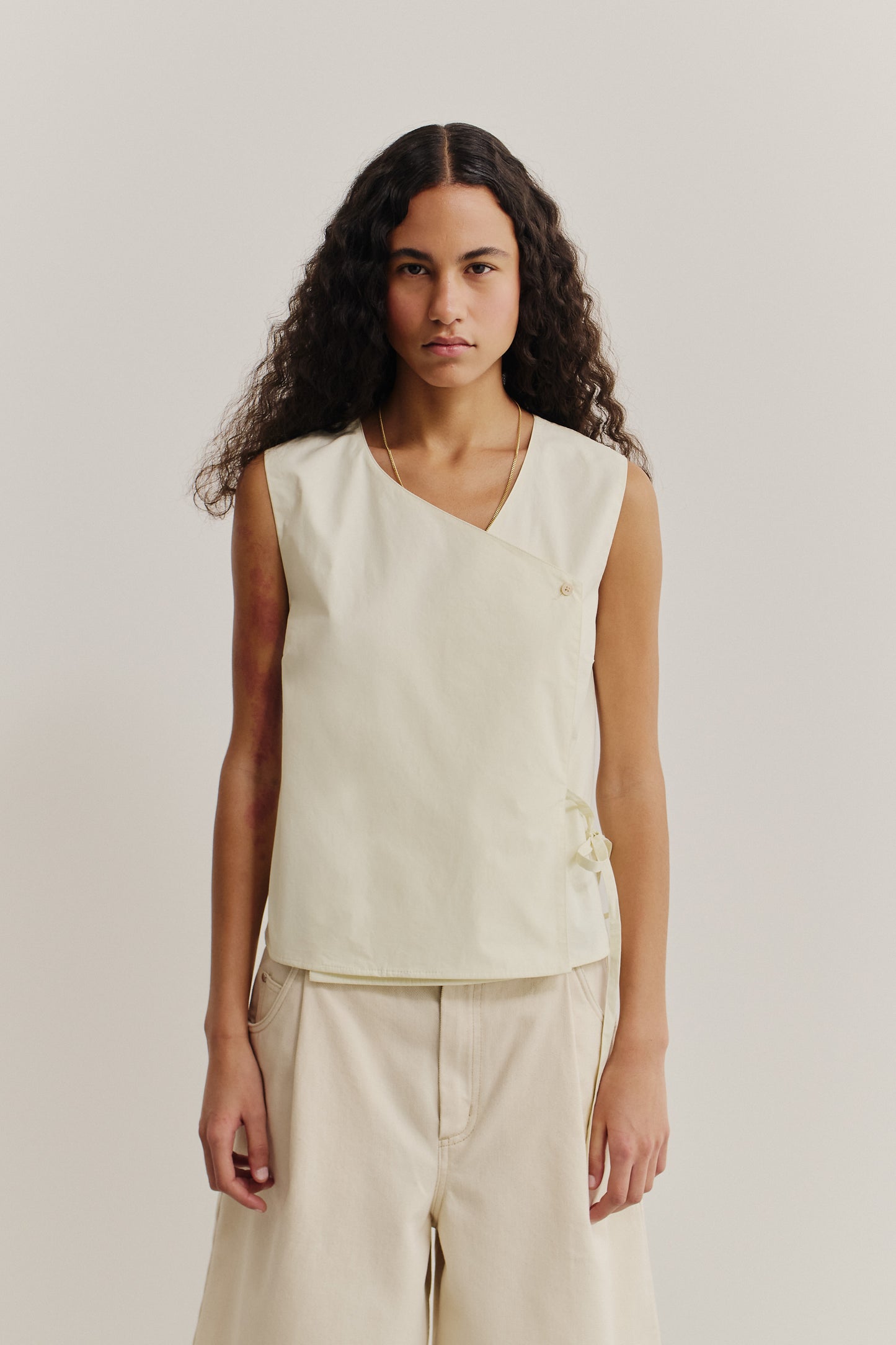 Women's sleeveless wrap shirt, organic cotton, garment washed, light beige, with V-neck and side ties.