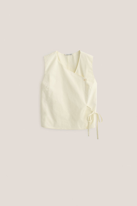 Women's sleeveless wrap shirt, organic cotton, garment washed, light yellow, with V-neck and side ties.