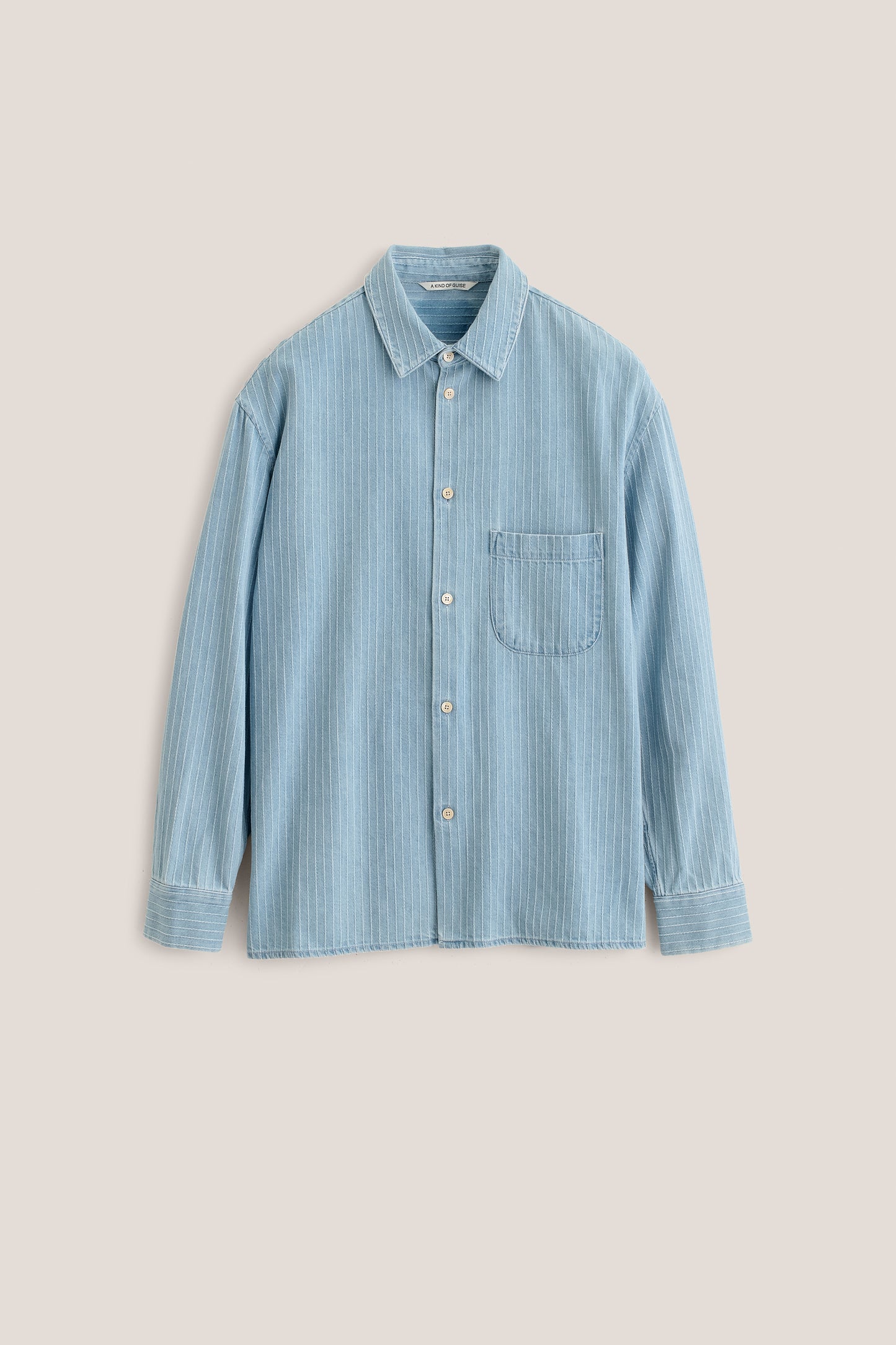 Men's long-sleeved shirt, organic cotton denim, washed light blue with white pinstripes, oversized fit, patch pocket.