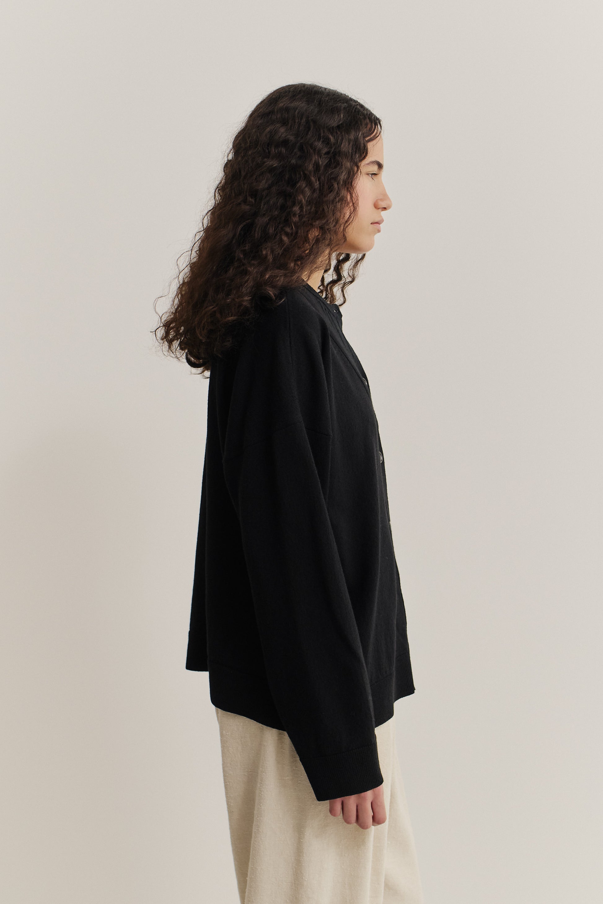Women's knit cardigan, 100% merino wool, black, relaxed fit, deep V-neck, ajour knit pattern.