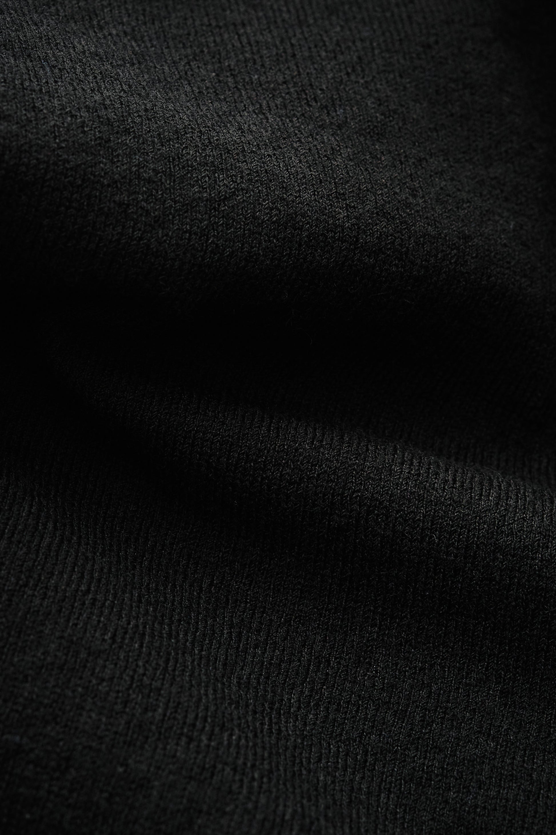 Women's knit cardigan, 100% merino wool, black, with ajour knit pattern and ribbed trim.