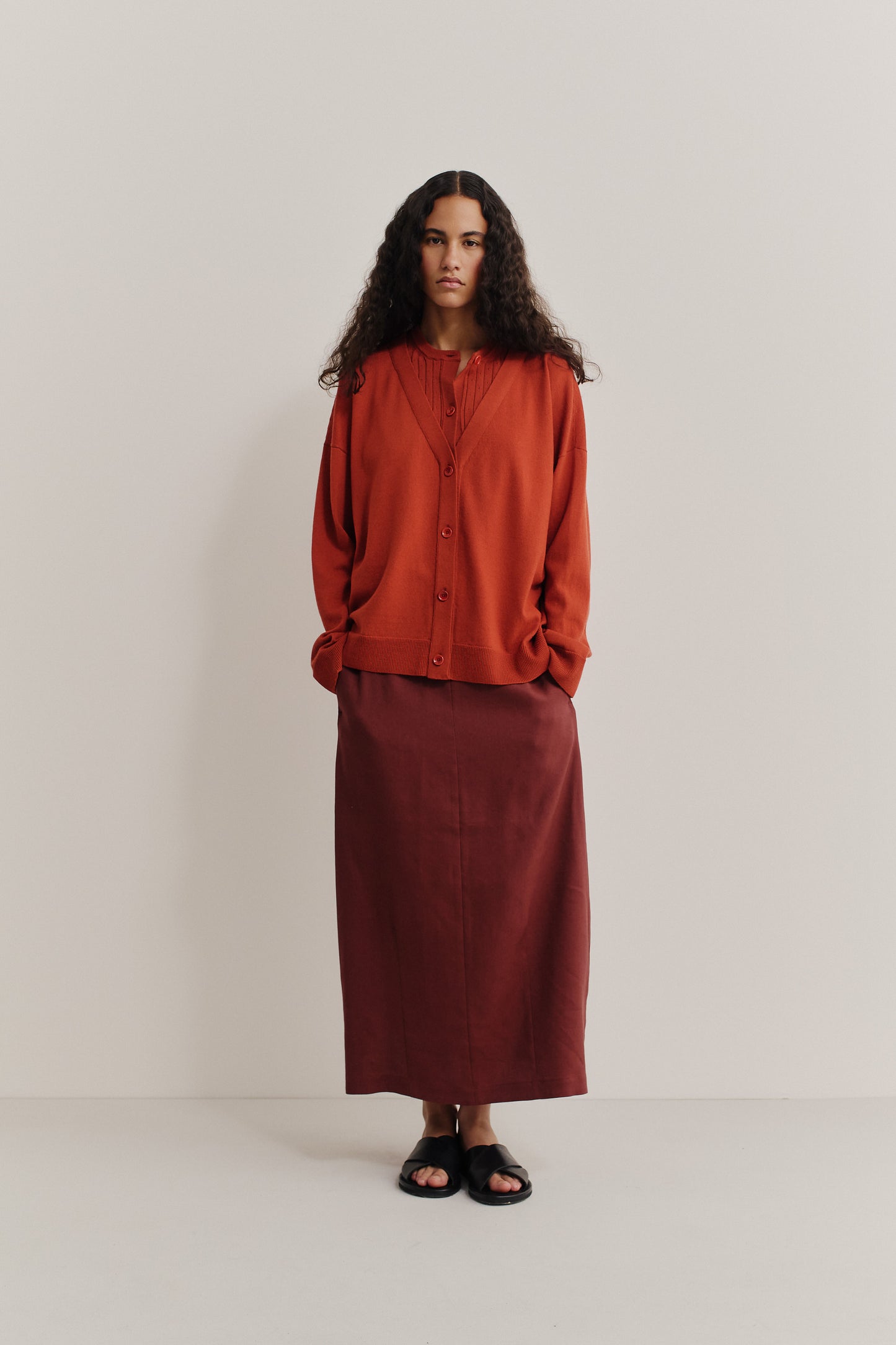 Women's knit cardigan, 100% merino wool, ajour knit, rust, with mock underlayer and dropped shoulders.