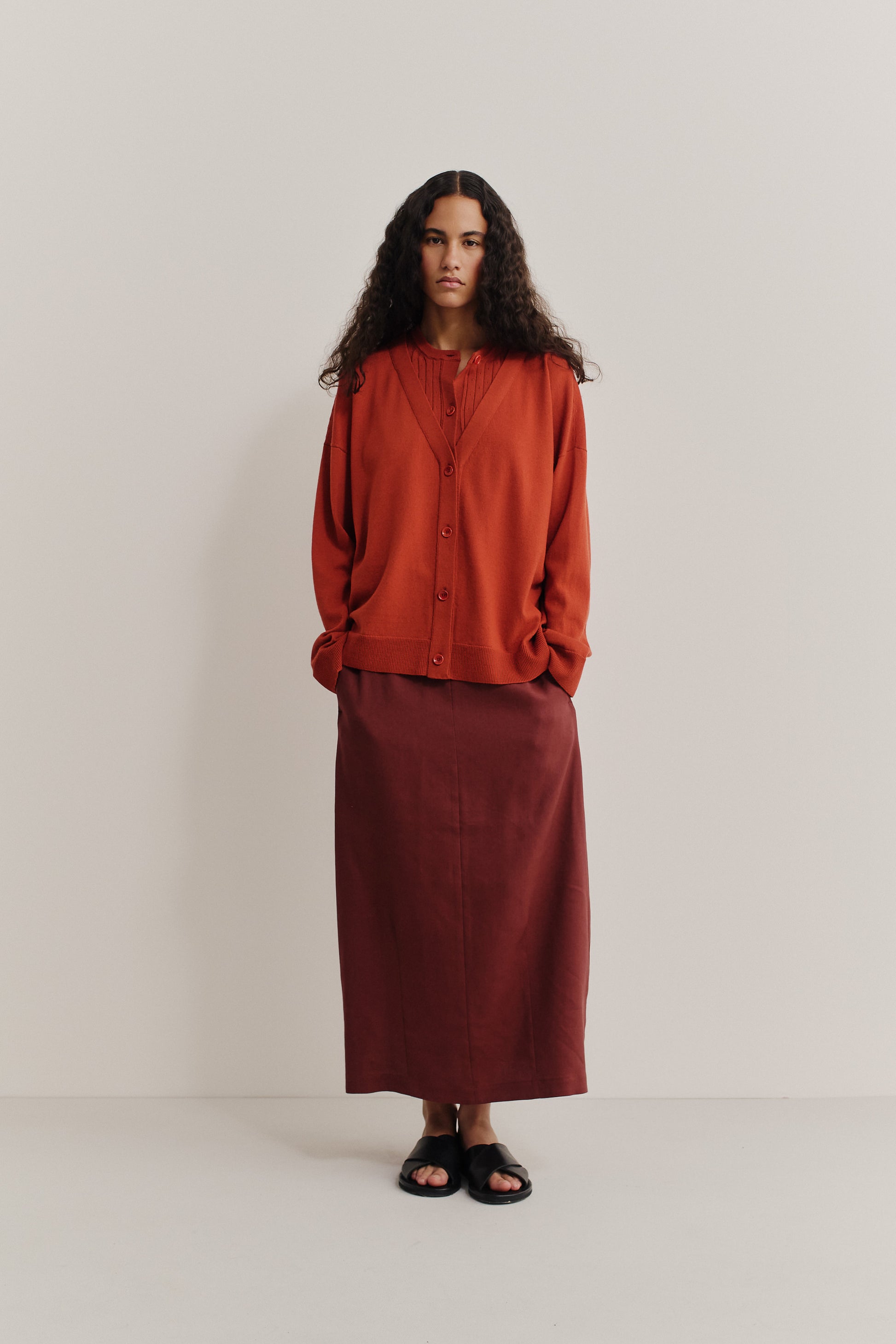 Women's knit cardigan, 100% merino wool, ajour knit, rust, with mock underlayer and dropped shoulders.