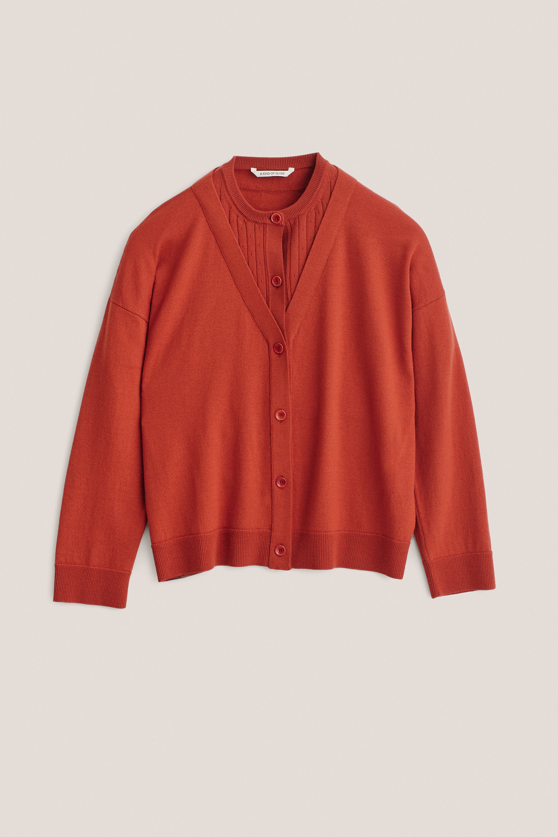 Women's knit cardigan, 100% merino wool, rust, with mock underlayer and ajour knit pattern.