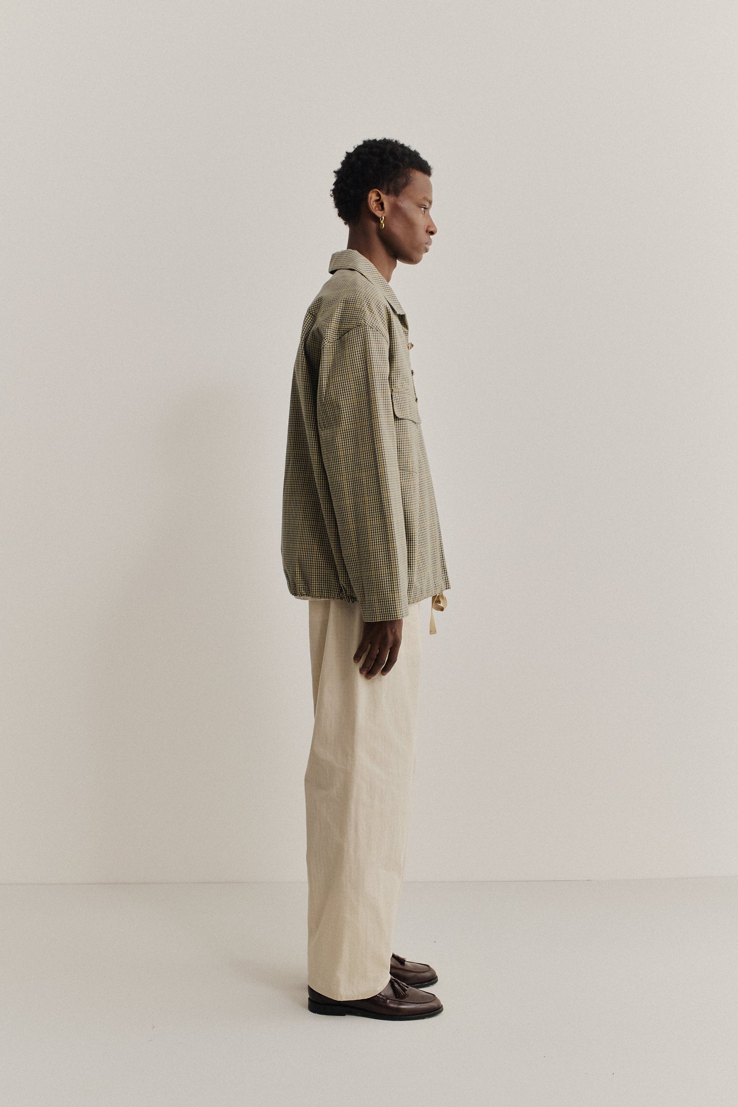 Men's long-sleeved shirt jacket, 100% cotton houndstooth in navy, green, and beige with yellow lines, patch pockets.