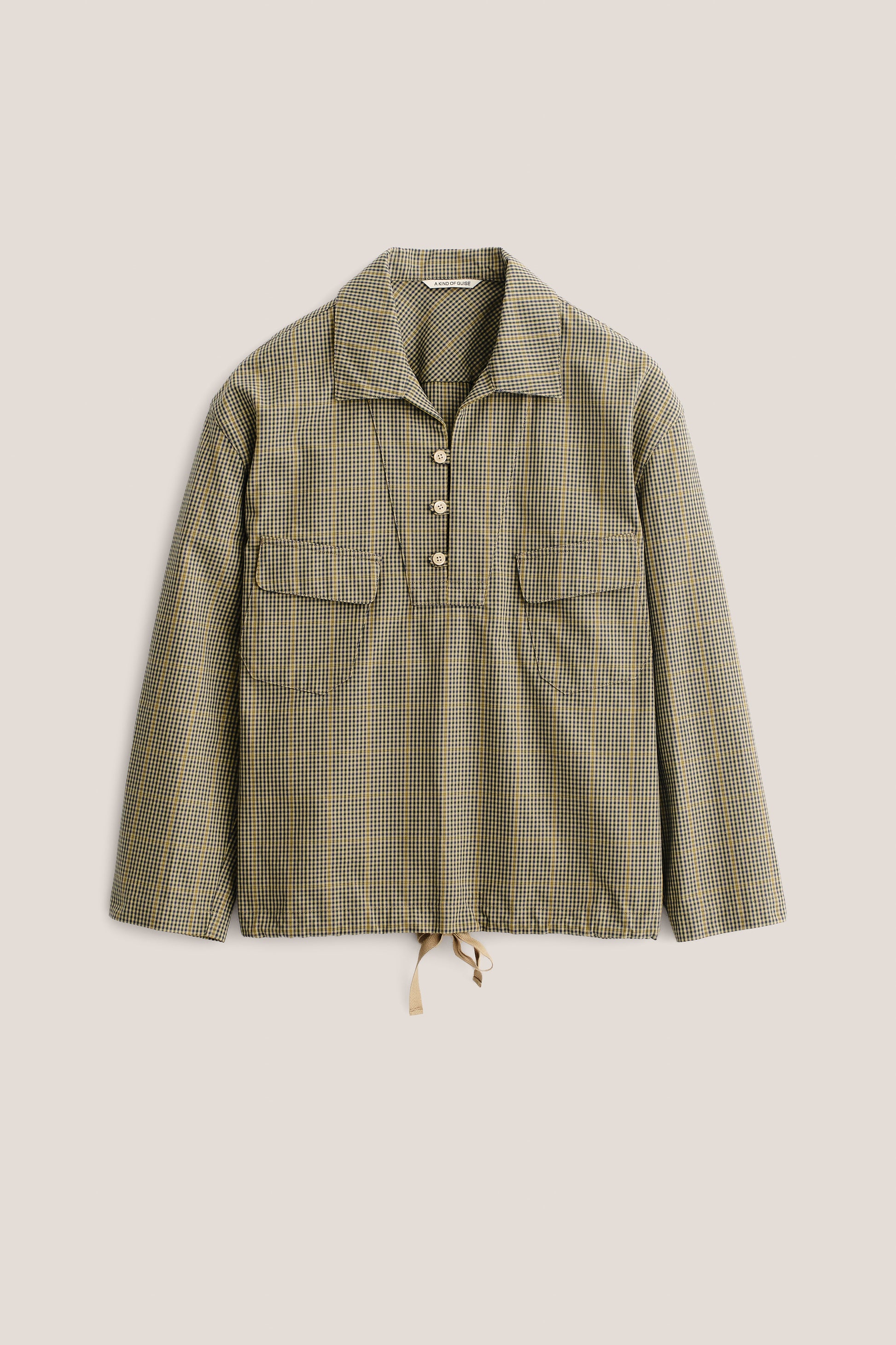 Men's long-sleeved shirt jacket, cotton houndstooth in navy, green, and yellow on beige, with patch pockets and drawstring hem.
