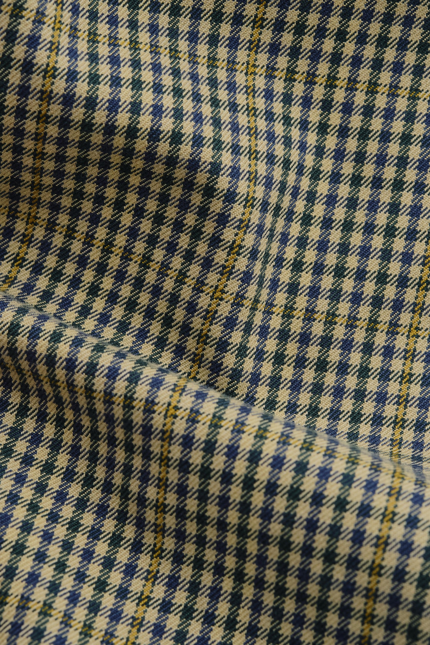 Men's long-sleeved shirt jacket, cotton houndstooth in navy, green, and beige with yellow plaid accents.