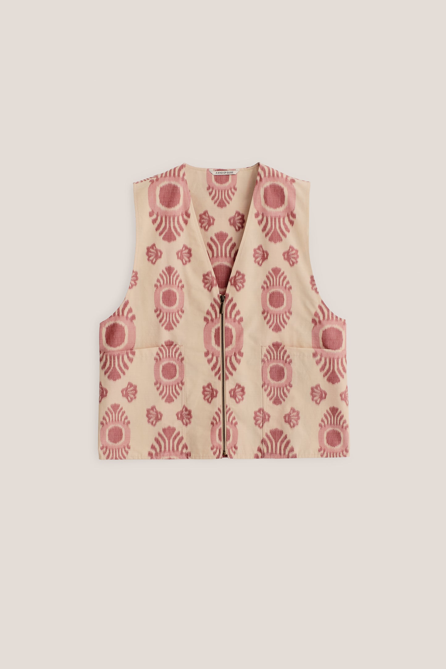 Men's outerwear vest, cotton-recycled polyester blend, ikat-patterned, beige with red motif, metal zipper, two patch pockets.