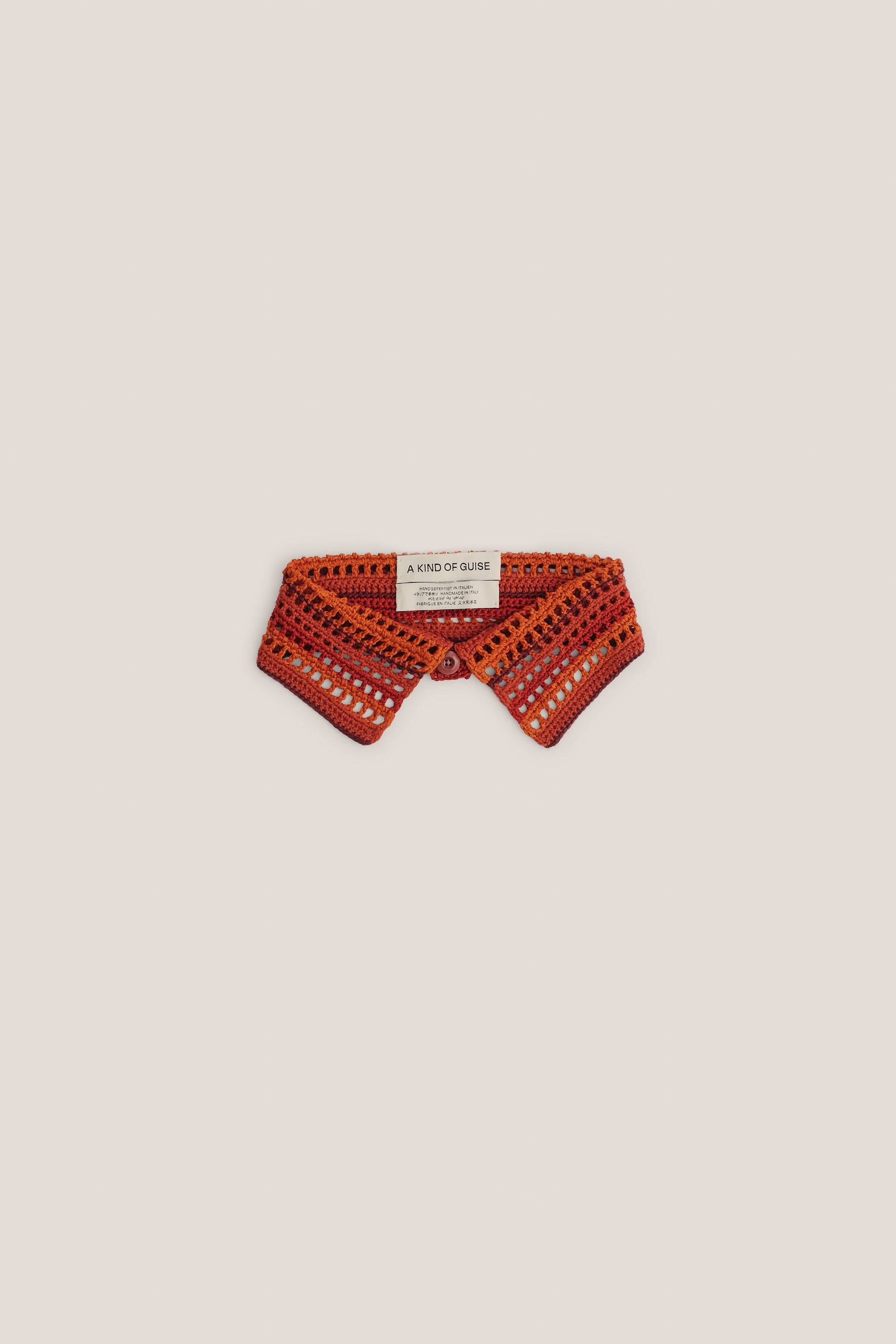 Women's accessory, hand-crocheted Kikoy Collar in orange and red merino wool, with button closure.
