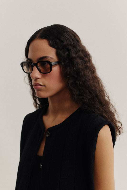 Women's accessories, black rectangular acetate sunglasses with subtly rounded edges and dark lenses.