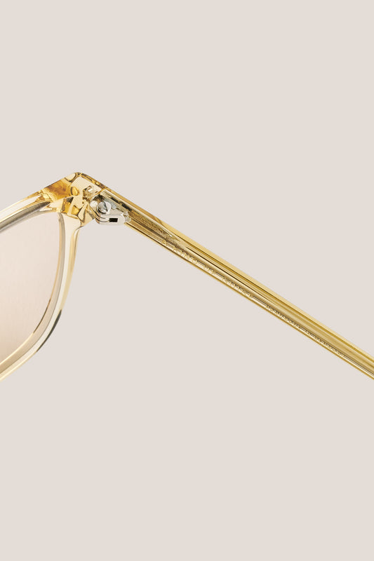 Unisex accessories sunglasses, transparent yellow acetate frame with light peach lenses.