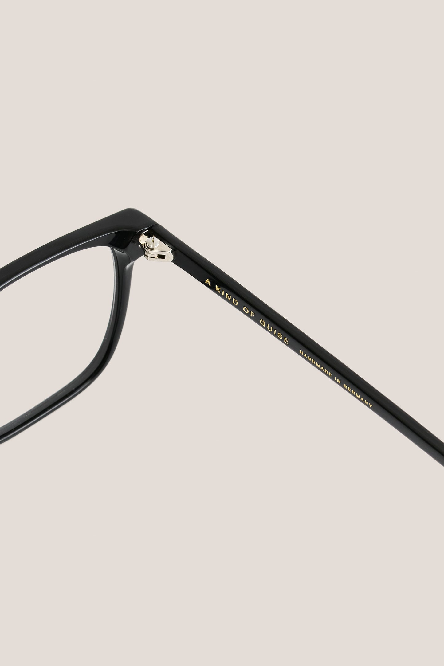 Unisex accessories eyewear, black acetate frame with clear lenses, gold "A KIND OF GUISE" text.