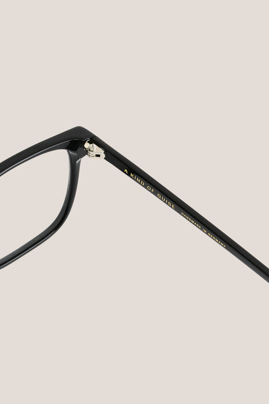 Unisex accessories eyewear, black acetate frame with clear lenses, gold "A KIND OF GUISE" text.