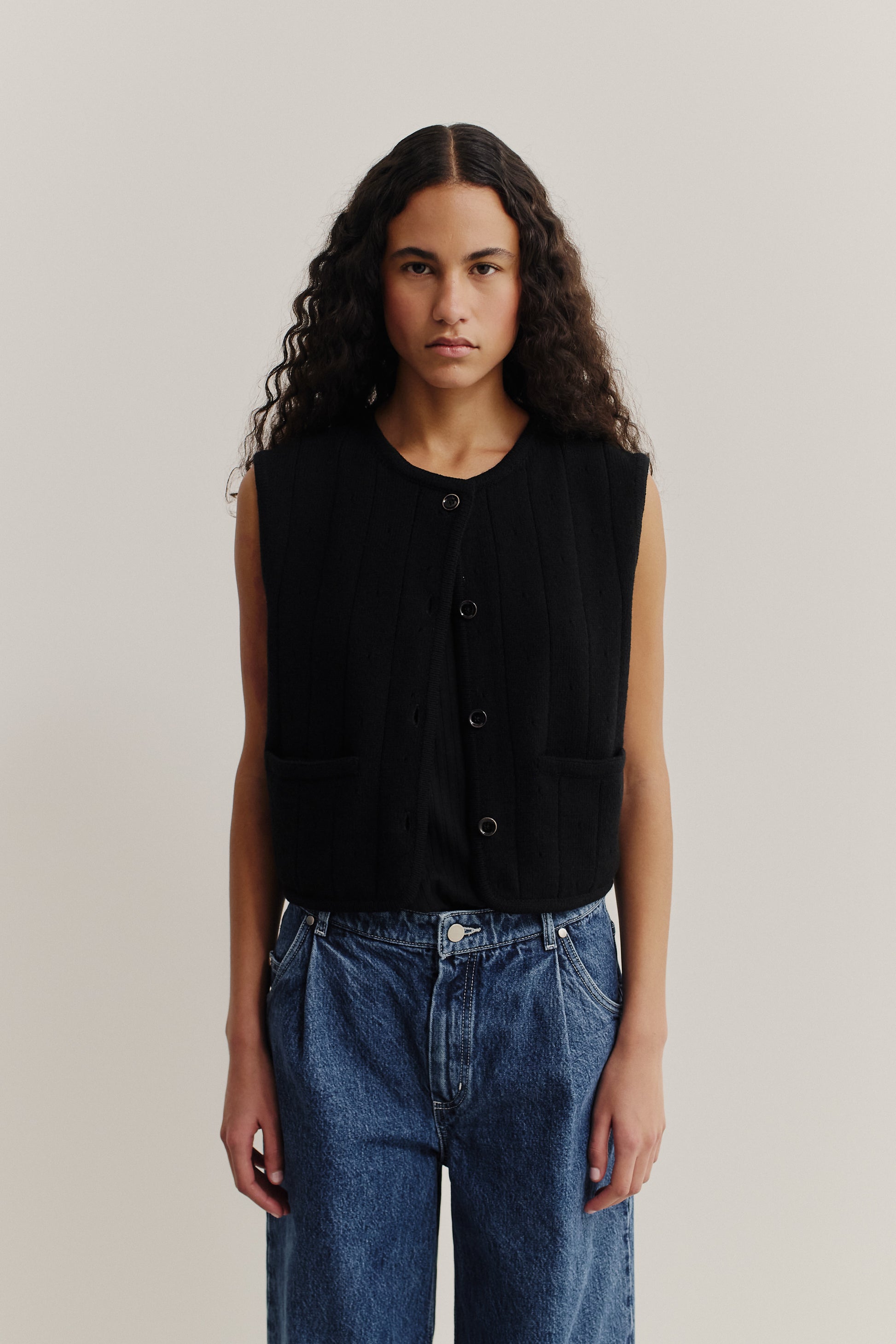 Women's knit vest, 100% merino wool, ajour knit, black, with front buttons and pockets.