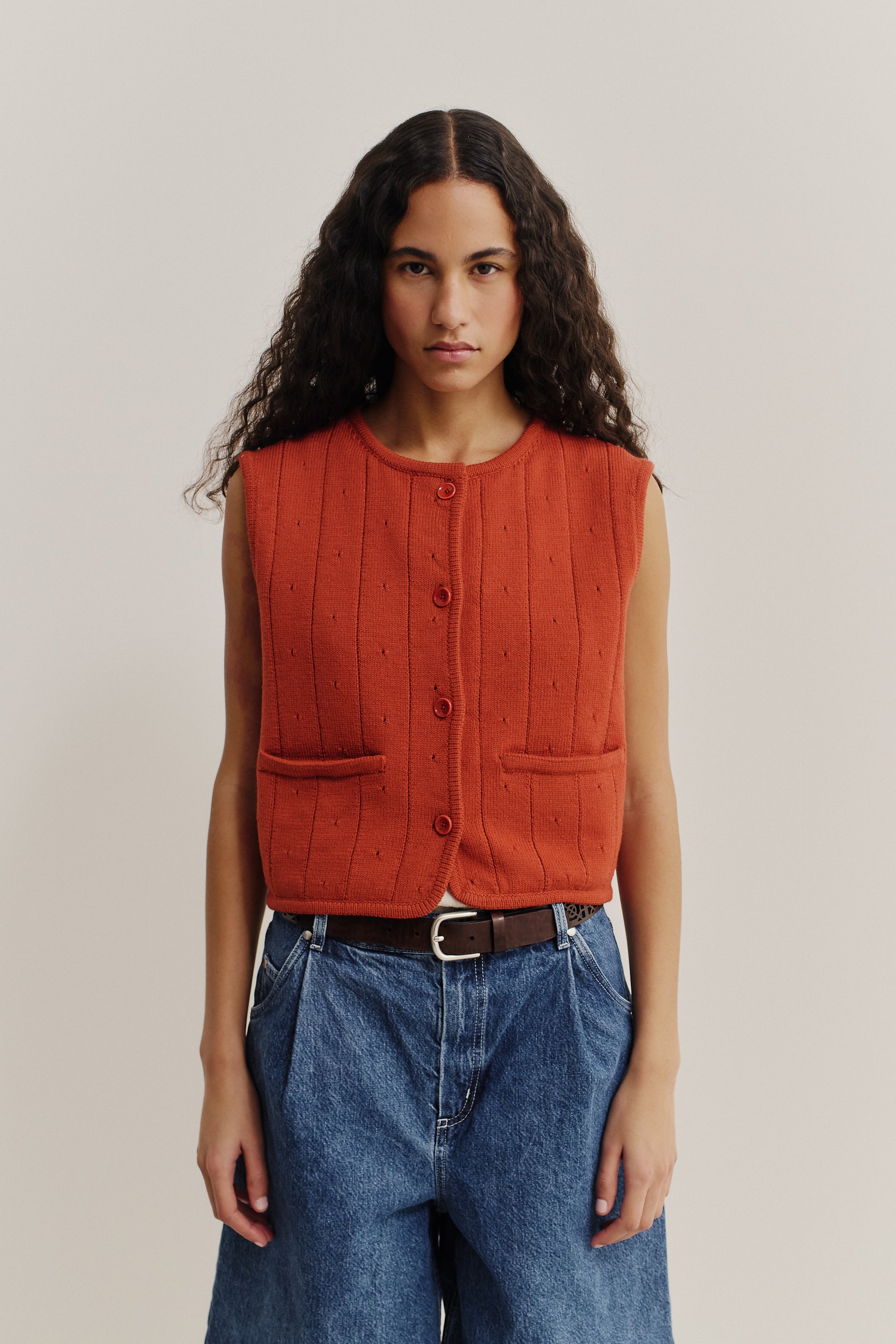 Women's knit vest, 100% merino wool, ajour knit, rust orange, button-front, with pockets.