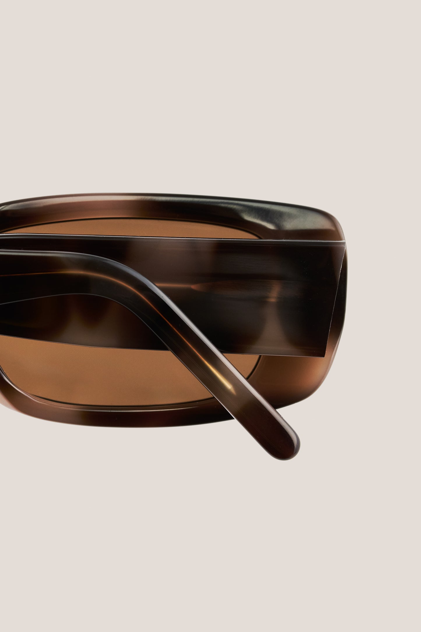 Unisex accessories sunglasses, wide and narrow acetate frame, tortoiseshell brown, with brown Carl Zeiss lenses.