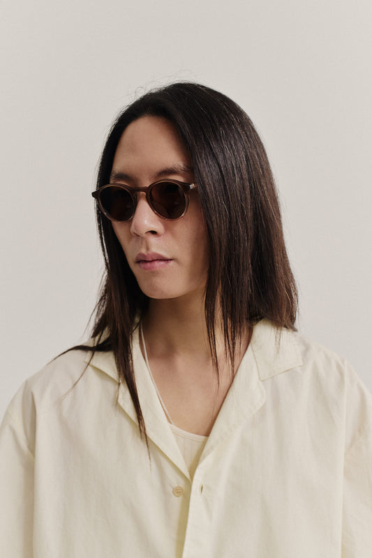 Unisex accessories sunglasses, Palermo Grande, brown acetate frames, Carl Zeiss® lenses, worn by a person with long dark hair.