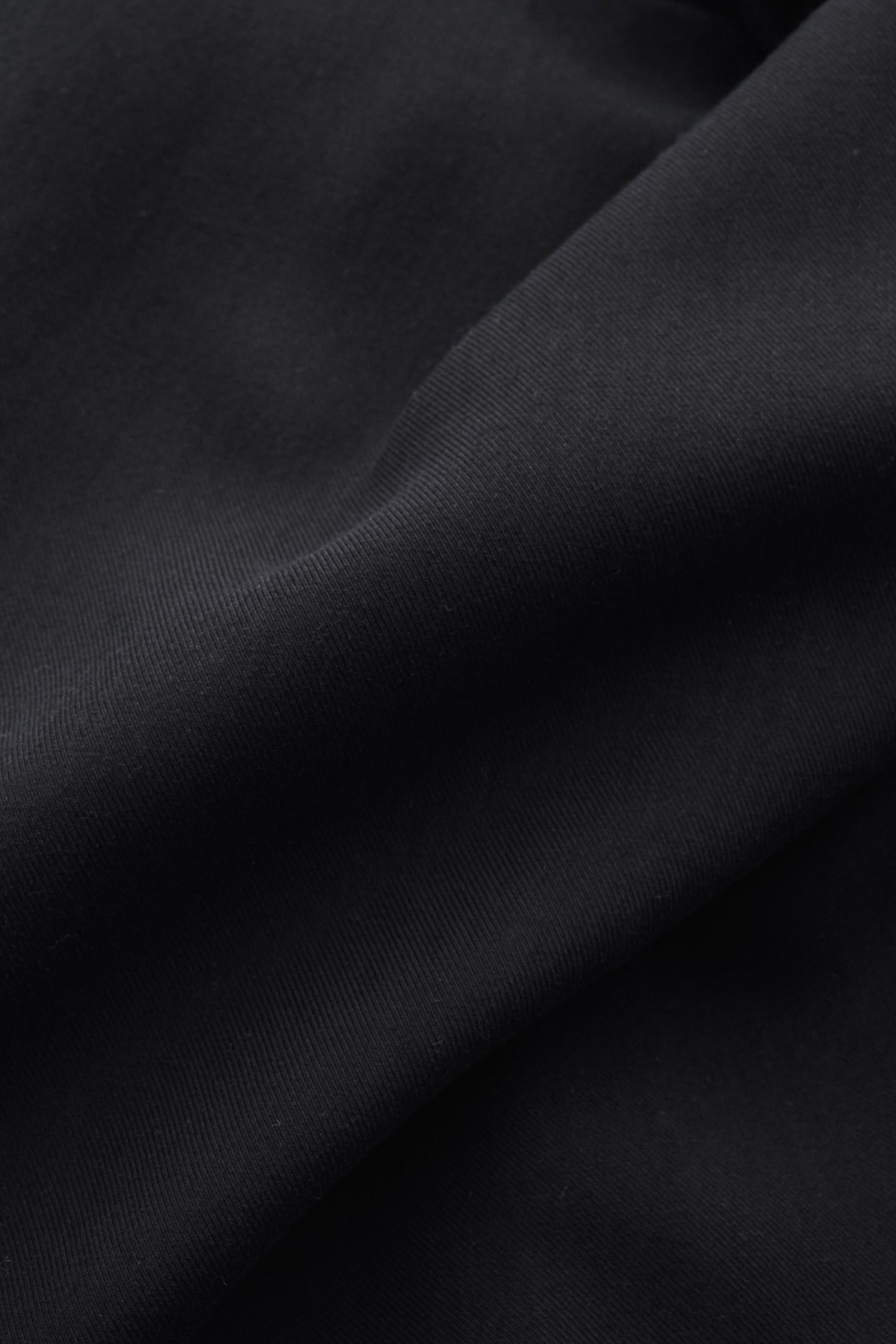 Men's tailoring blazer, 100% lyocell heavy twill, deep black, fluid drape, matte surface.